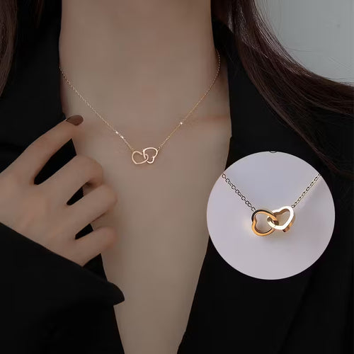 Model wearing personalized double heart name necklace with engraved hearts