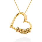 Gold personalized engraved bead necklace with heart pendant on white background