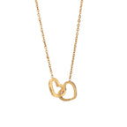Gold personalized double heart name necklace on white background