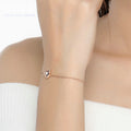 Woman wearing garnet geometric bracelet, January birthstone jewelry