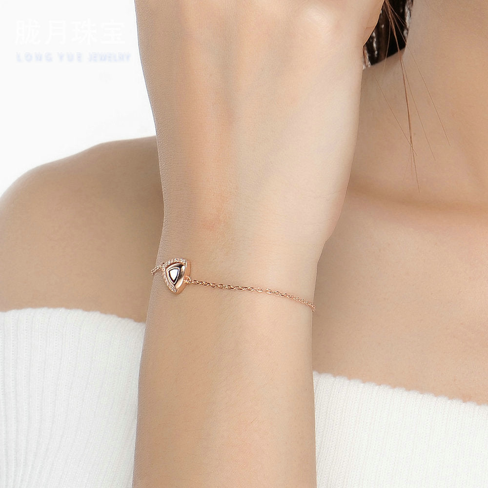 Woman wearing garnet geometric bracelet, January birthstone jewelry