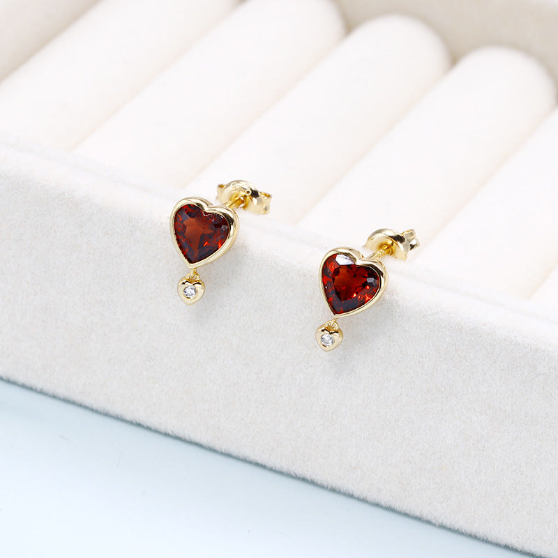 Top view of garnet heart studs with sterling silver setting