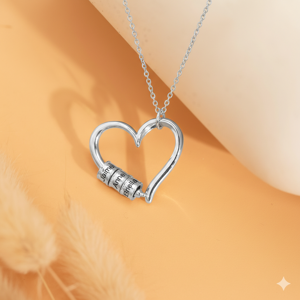 Silver personalized heart bead necklace with custom engraving on styled background