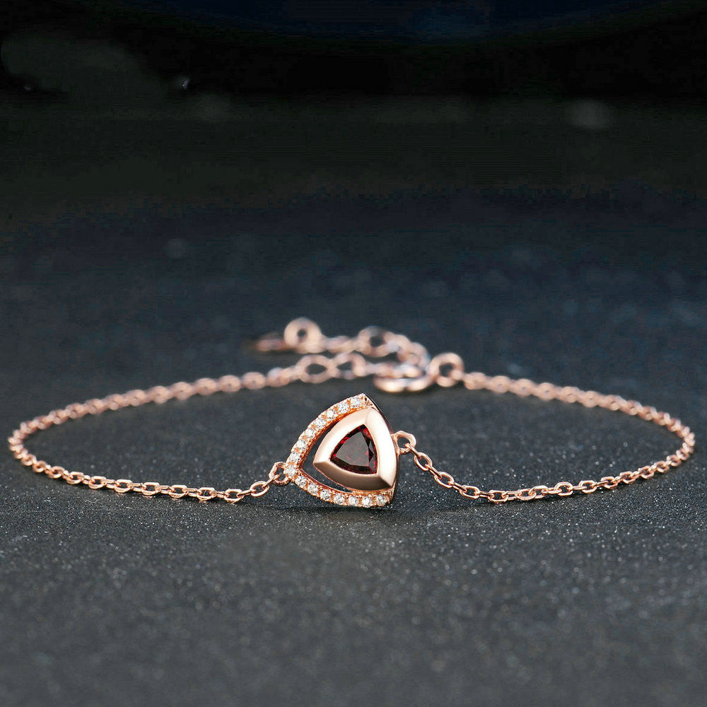 Detailed shot of garnet gemstones in silver geometric bracelet