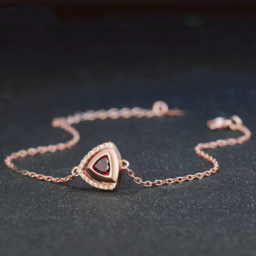 Silver garnet necklace with red garnet pendant on black background