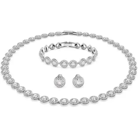Everyday silver jewelry with necklace bracelet and earrings on soft gray background